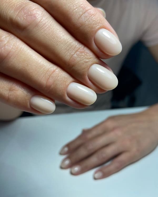 Milky white oval Russian manicure with a glossy natural finish